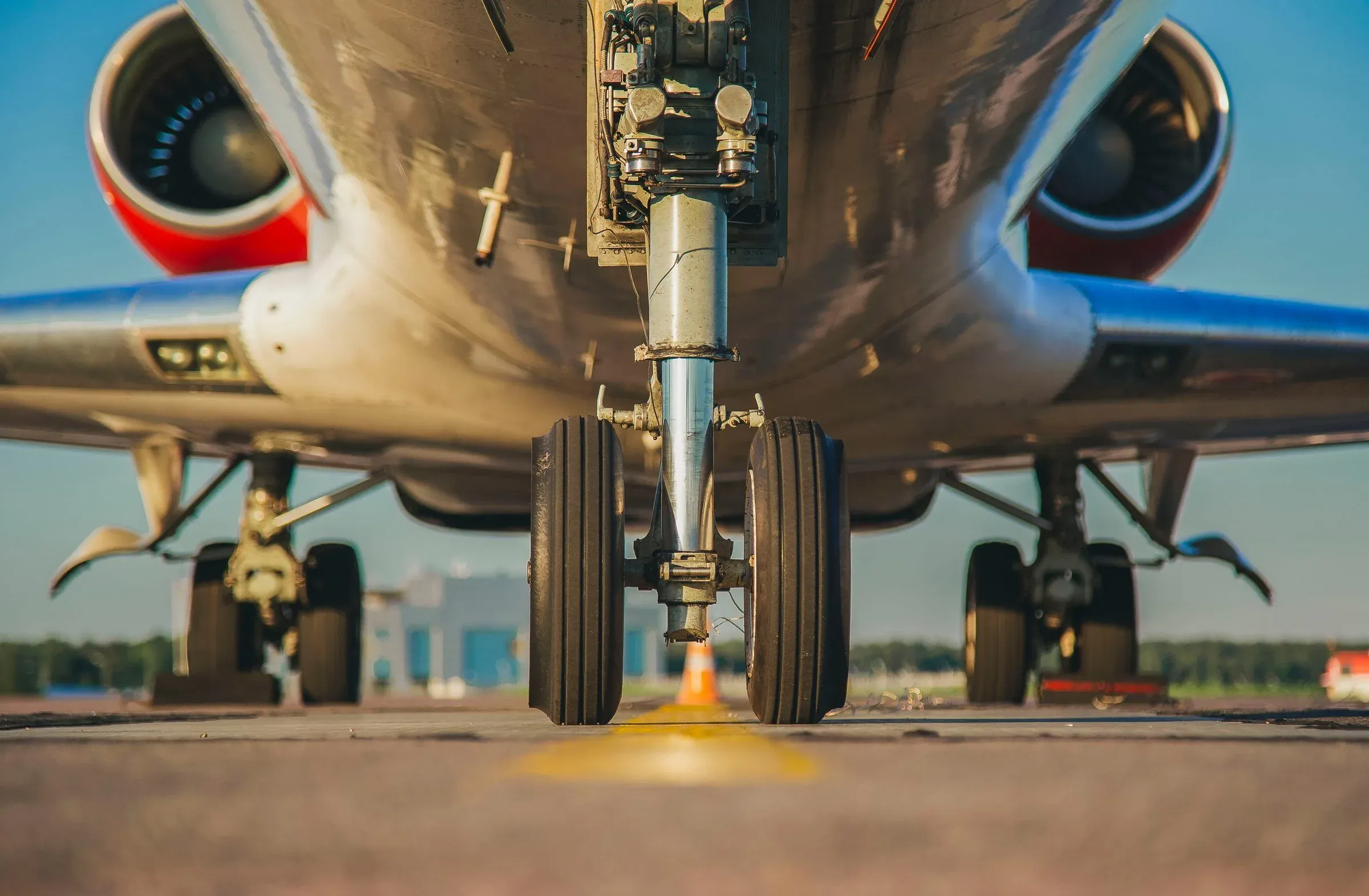 Close-up of an airliner's landing gear resting on the tarmac.
